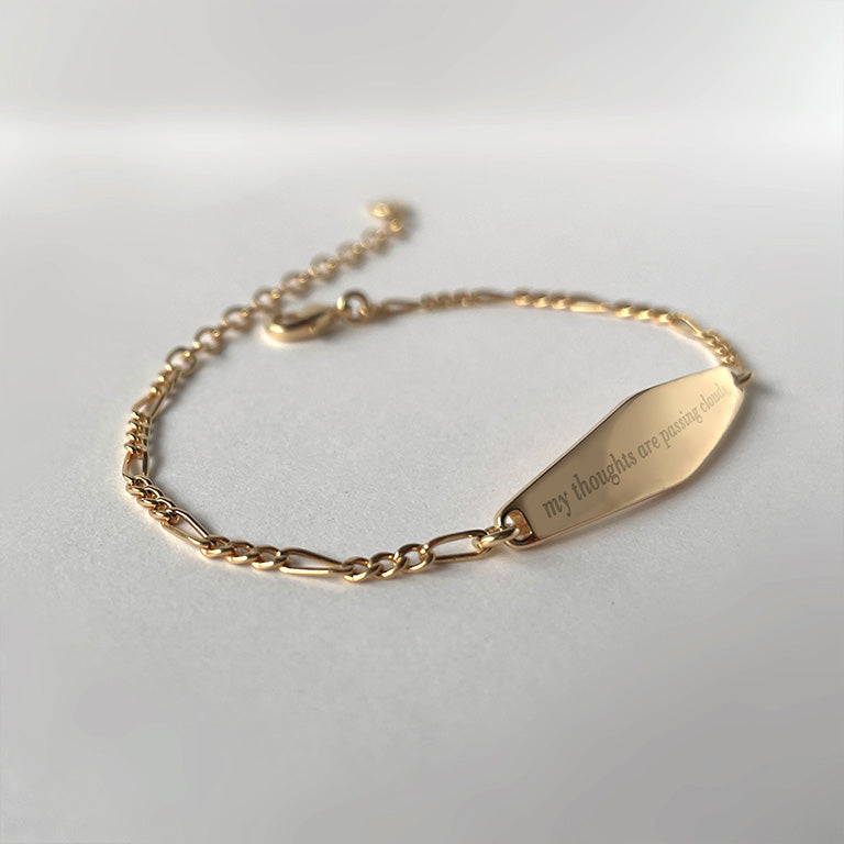 Gold Figaro Chain Bracelet engraved with the phrase 